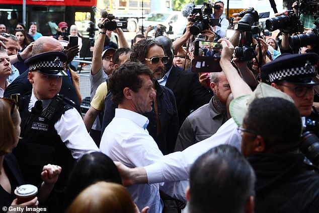 As he queued for security inside the court, Brand was seen touching a lawyer¿s shoulder seemingly to check they were ok
