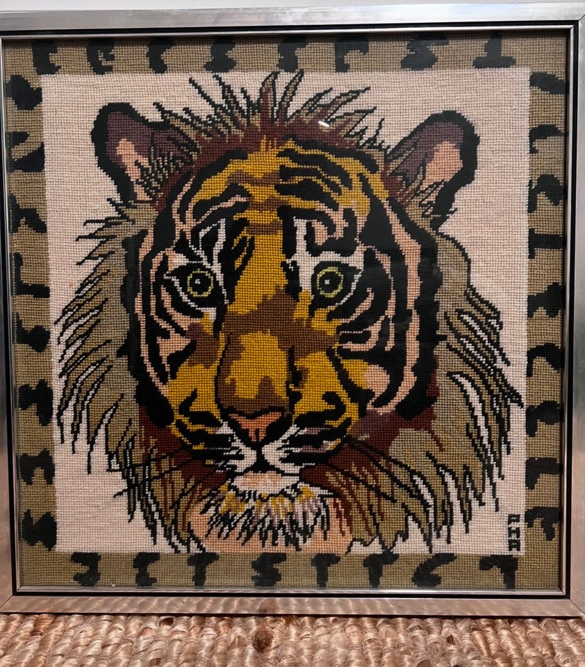 Needlepoint of a tiger's face.
