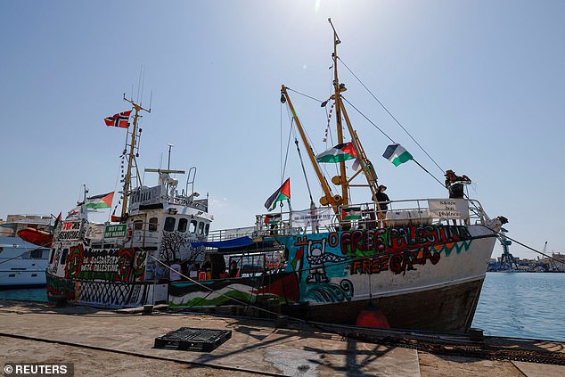 Activists wash the deck of the Freedom Flotilla Coalition ship 'Handala' as they prepare to sail for Gaza in 2024