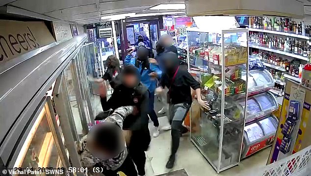 CCTV footage shows the gang surrounding the worker who was pinned against the doors of the fridges