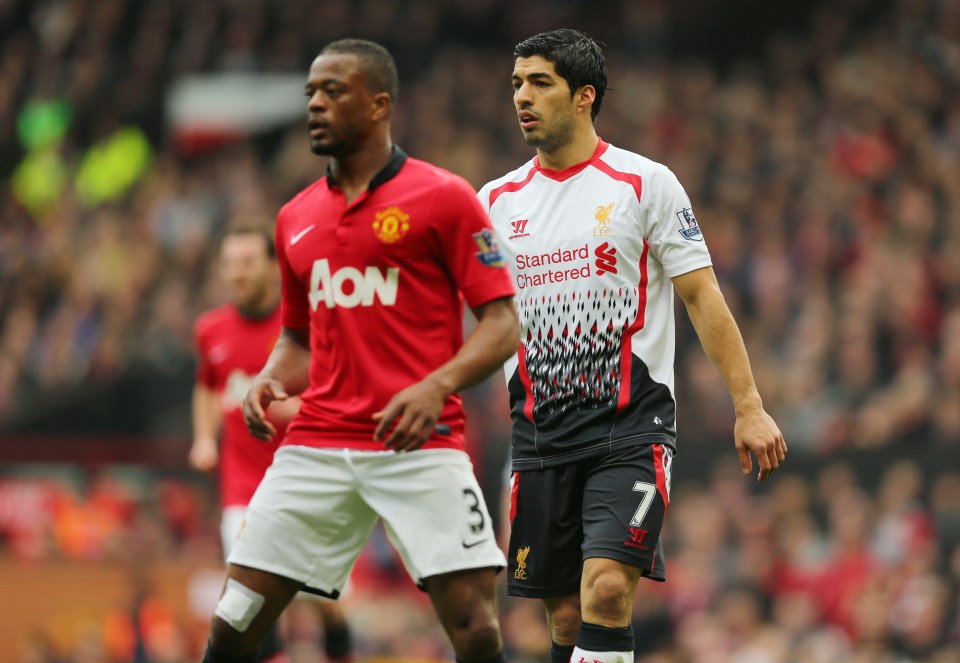 Patrice Evra of Manchester United and Luis Suarez of Liverpool during a soccer match.