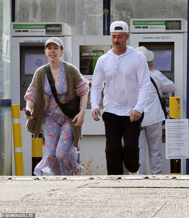 Katherine was casually clad for the outing in a floral dress that she paired with a pink and khaki oversized cardigan and a grey baseball cap
