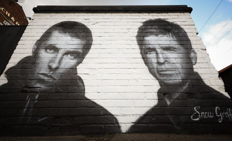 Mural of Liam and Noel Gallagher of Oasis on a brick wall.