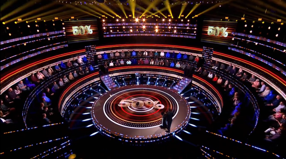 Game show set with audience and host.