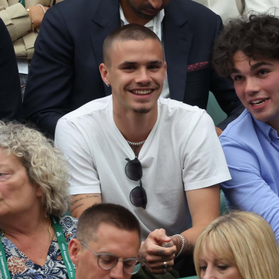 Romeo Beckham watching a Wimbledon tennis match.