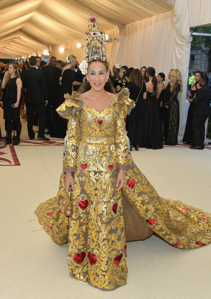 Sarah Jessica Parker at the Met Gala in a gold gown and elaborate headpiece.