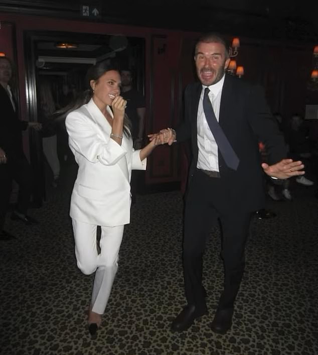David and Victoria looked as loved up as ever as they held hands on a swanky night out, with David wearing a black suit, white shirt and blue tie and his wife wowing in all white