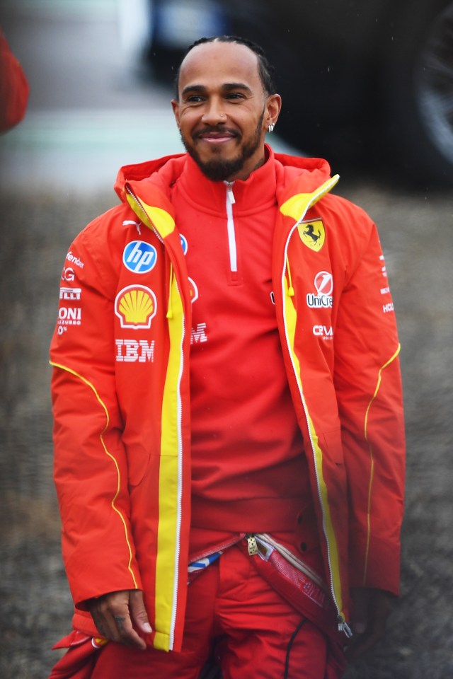 Lewis Hamilton in a red Ferrari jacket.