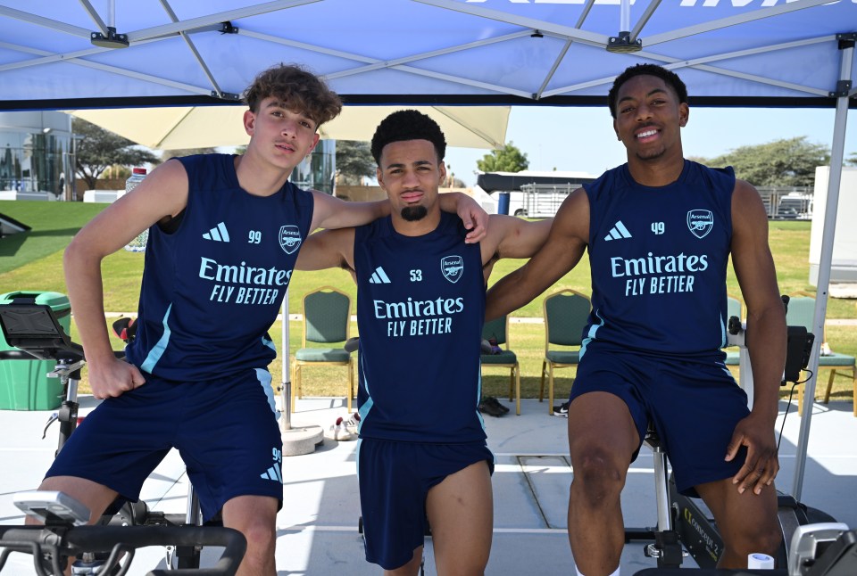 Three Arsenal youth players on stationary bikes during training.