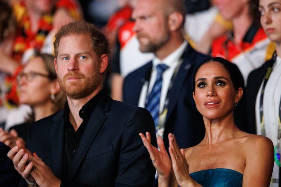 Prince Harry and Meghan, Duchess of Sussex, clapping at the Invictus Games Düsseldorf 2023 closing ceremony.