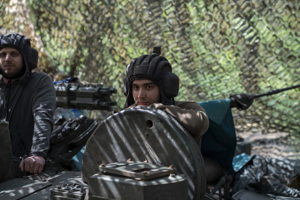 Ukrainian military engineers maintaining a captured T80 tank.