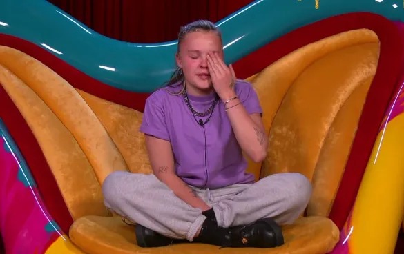 Jojo Siwa wiping away tears.