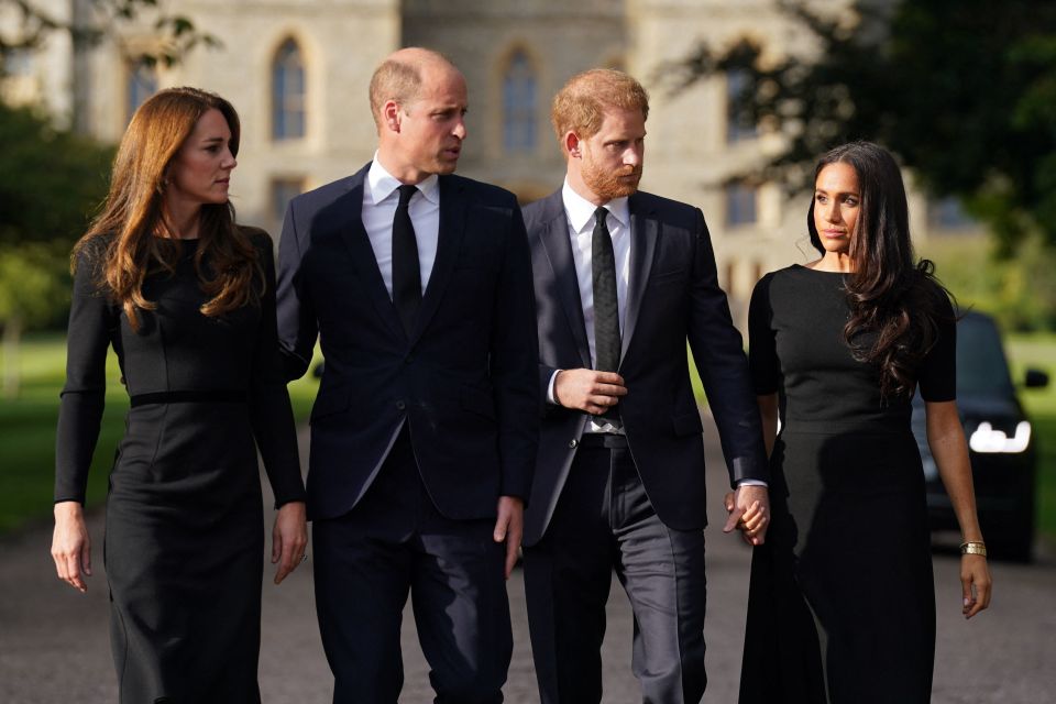 Prince William, Kate Middleton, Prince Harry, and Meghan Markle walking together at Windsor Castle.