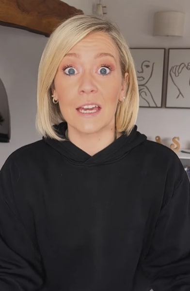 Woman in black hoodie looking at the camera.