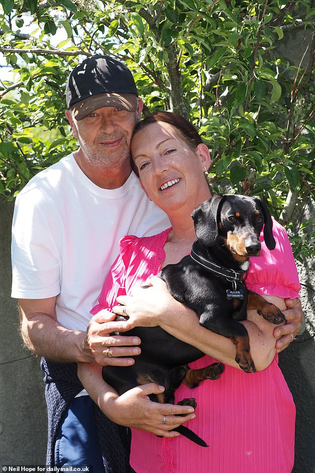Ms Colwill has endured 15 years of abuse from trolls. She is pictured with husband Patrick and their dog Oskar