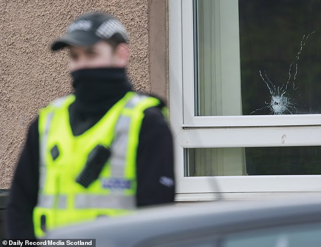 In Edinburgh, one home's window had a visible bullet hole (pictured) after a related attack last month. Police Scotland have arrested at least 20 people in connection with the violence in Glasgow and Edinburgh
