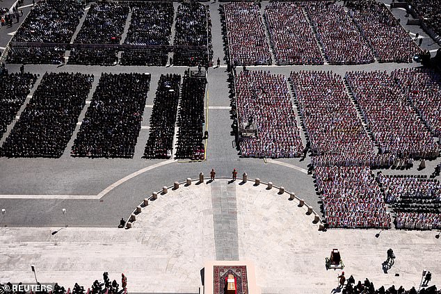 People attend the funeral Mass of Pope Francis at the Vatican, on Saturday April 26