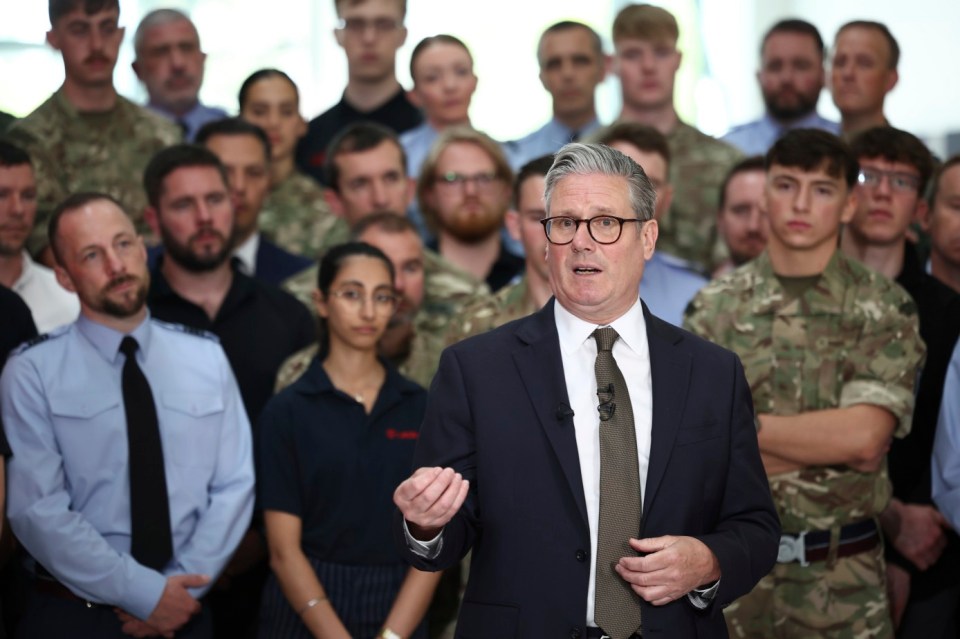 Keir Starmer speaking to a group of uniformed personnel.