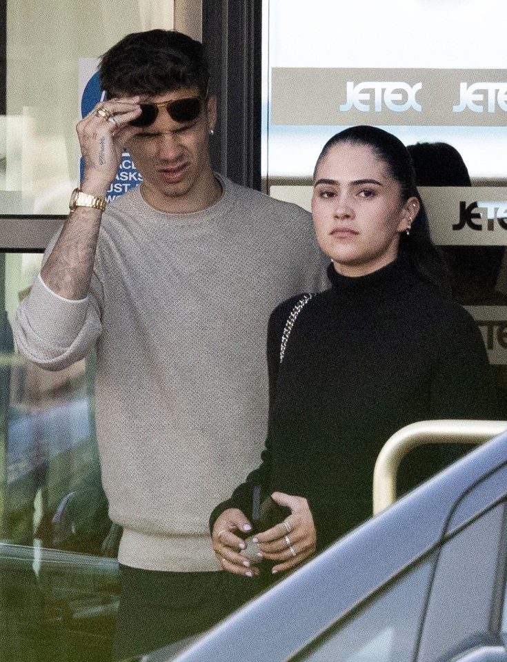 Romeo Beckham and his partner arriving at an airport.