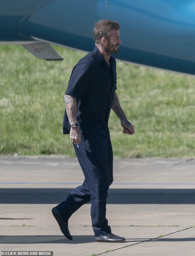 David kept it casual in a black short-sleeved shirt and black trousers and shoes