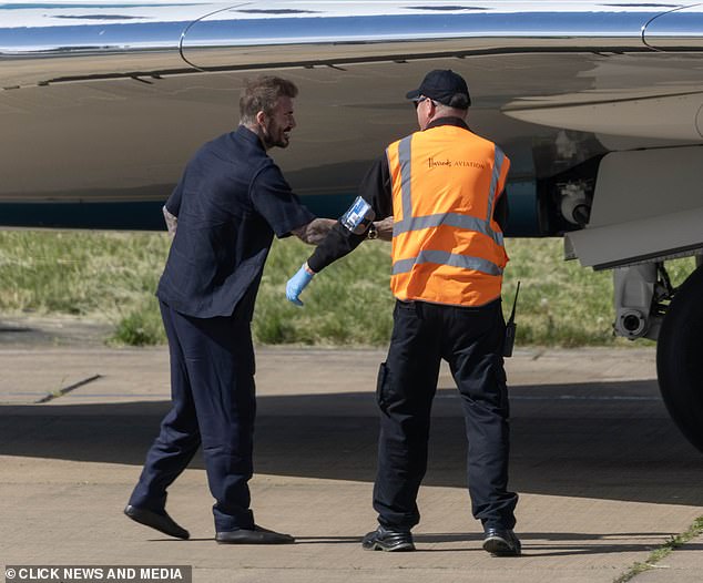 David was seen shaking hands with the staff on the ground after they landed