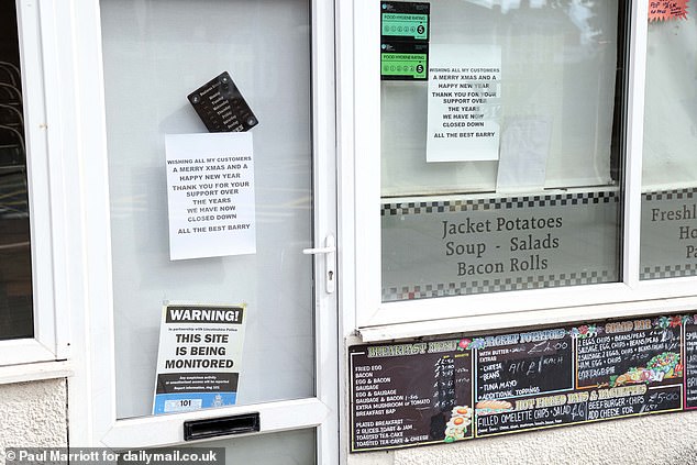 A restaurant with a sign announcing they had closed around the festive season in 2024 and another warning people the 'site is being monitored'