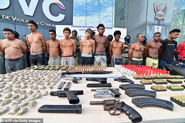 Detainees, weapons, drugs an ammunition are presented to media members after an operation carried out in the neighborhood where at least 22 people were killed on the eve in Guayaquil, Ecuador, on March 7, 2025