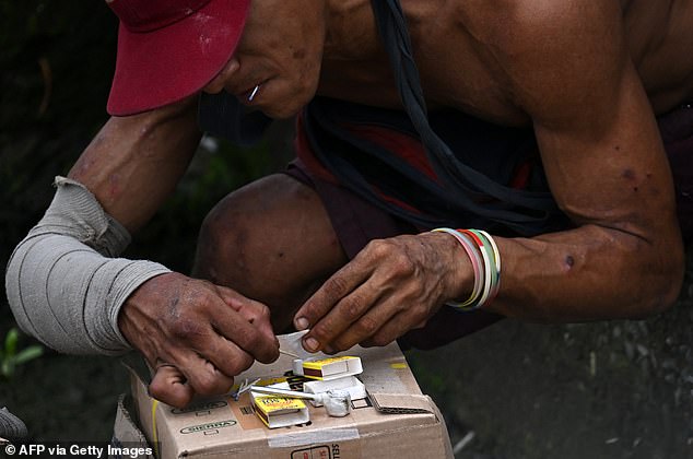 A man prepares bazuco, a low cost drug derived of processing cocaine, in Guayaquil on April 11, 2025