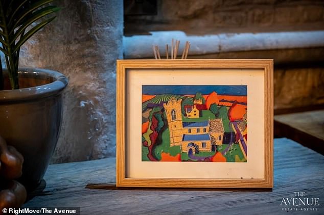 A hint of colour is brought to the property by way of a picture of the church itself that has been put on display