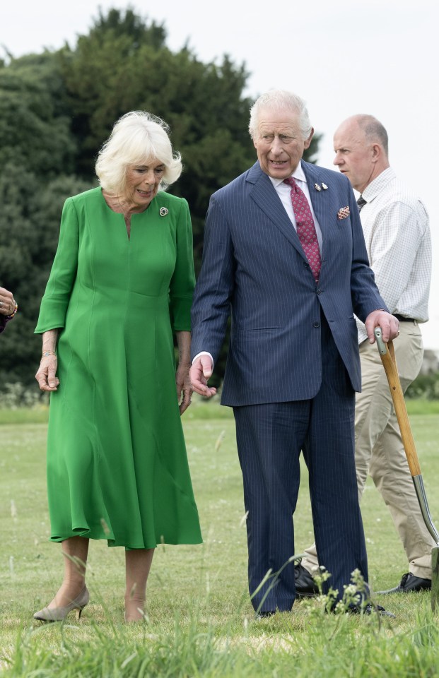 King Charles III and Queen Camilla planting a tree at Windsor Castle.