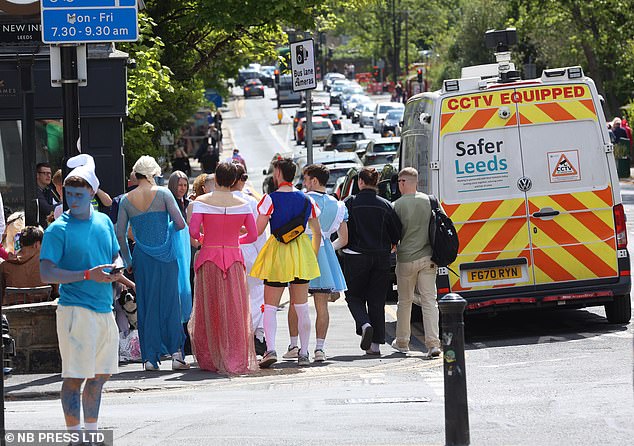 Pictured: One reveller can be seen painted blue and in a smurf outfit