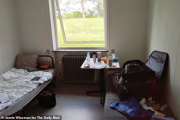 Ndam's room in the deportation centre, with a single bed and small sofa