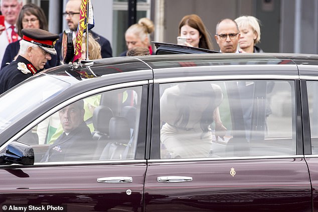 Meghan can be seen entering the car first and moving along to sit behind the front passenger