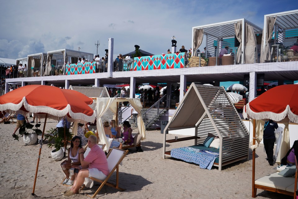 Spectators at a Formula One race on a man-made beach.