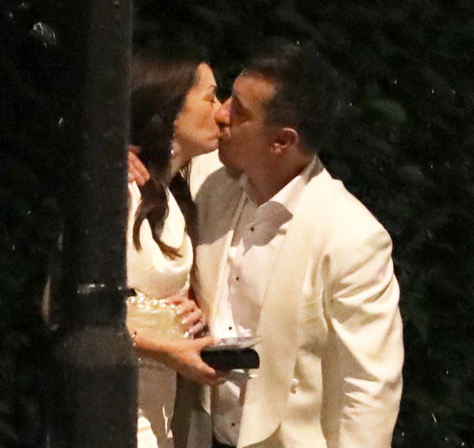 Gary Neville and his wife kissing at a party.