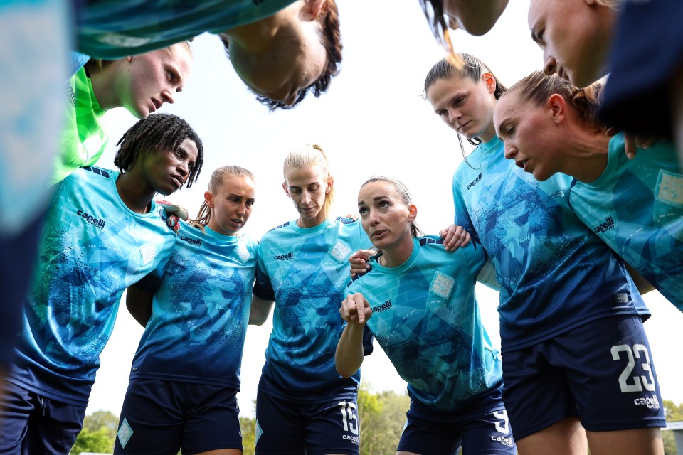 London City Lionesses soccer team huddles.