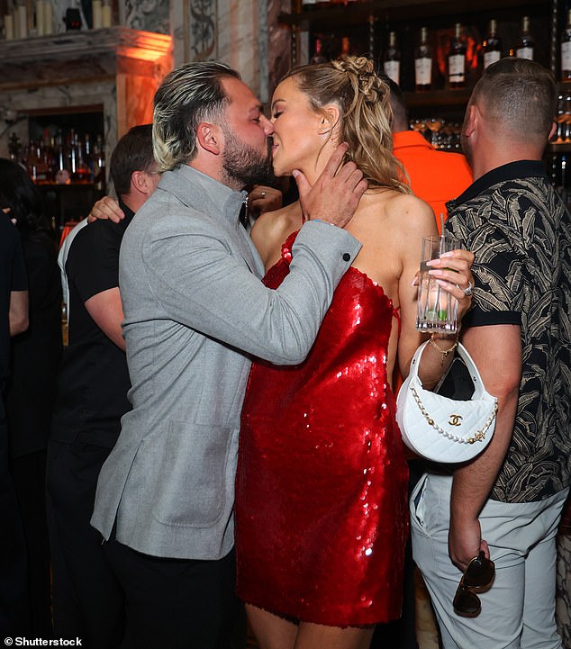 She also packed on the PDA with her husband Bradley Dack, 31, who was wearing a grey zip-up jumper underneath his blazer
