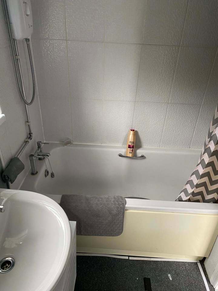 Bathroom with bathtub, sink, and shower.