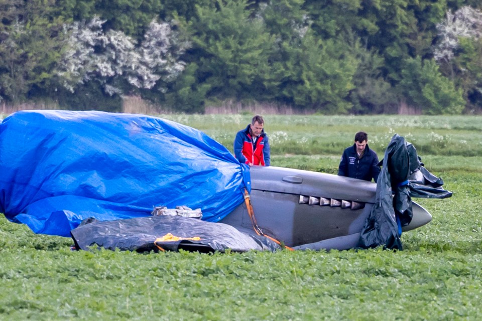 Volunteers protecting a crashed 1940s Spitfire.