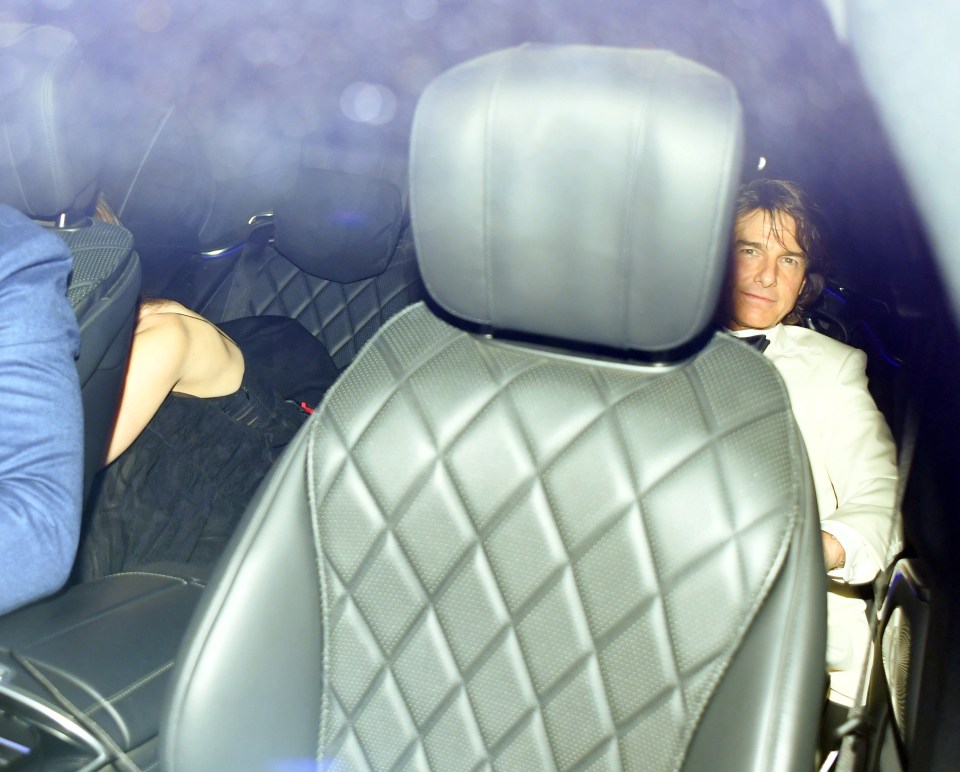 Tom Cruise and Ana de Armas leaving a party in a car.