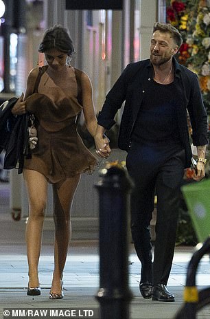 They walked down the street holding hands