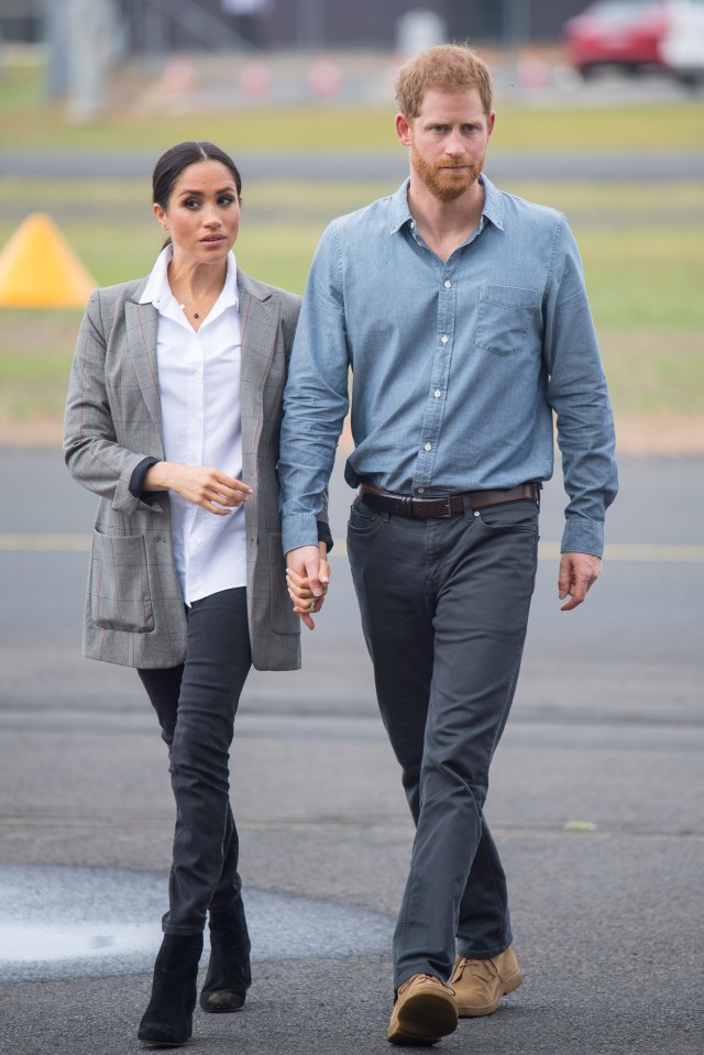 Meghan Markle and Prince Harry holding hands.