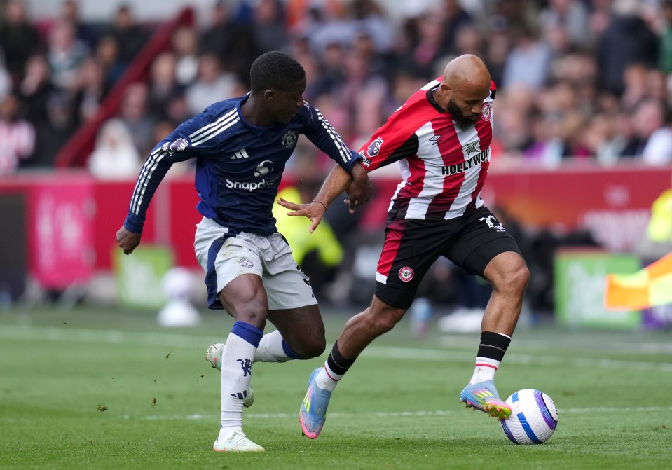 Manchester United's Kobbie Mainoo and Brentford's Bryan Mbeumo battling for the ball during a Premier League match.