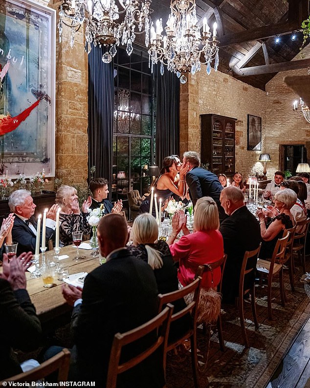 The smitten couple kissed over the table as they enjoyed the intimate family dinner