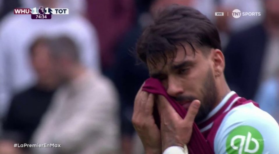 Upset soccer player wiping tears.