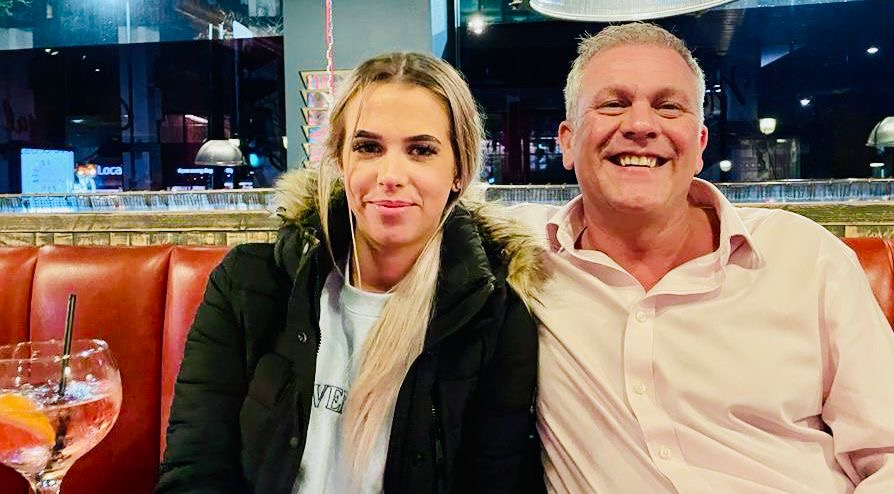 Photo of a father and daughter sitting together.