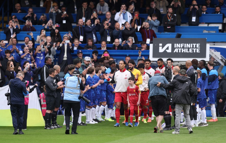 Liverpool's Virgil van Dijk and teammates receiving a guard of honor from Chelsea players.