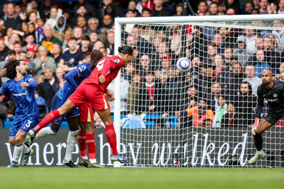 Virgil van Dijk heads the ball into the goal during a soccer match.