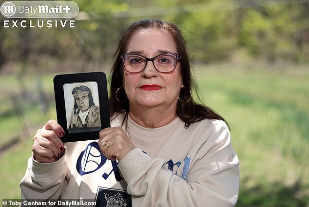 Rogers' wife Judy holding a picture of her wartime pilot Father Ellis Sappington, a crew member of the aircraft that tailed after the plane that dropped the nuclear bomb on Hiroshima