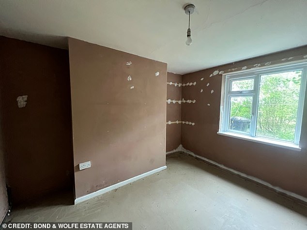 Spackling paste has been used to fix holes in the walls where shelves likely hung